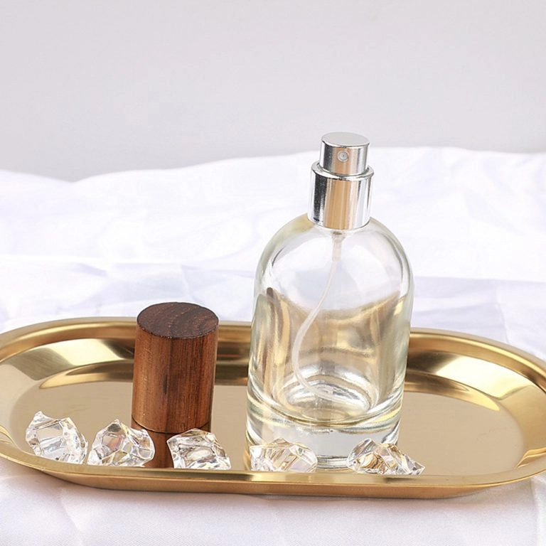 Clear round perfume bottle with silver spray pump and wooden cap