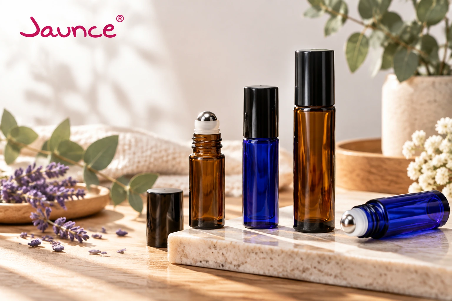 Jaunce glass roller bottles in amber and blue colors for essential oil packaging